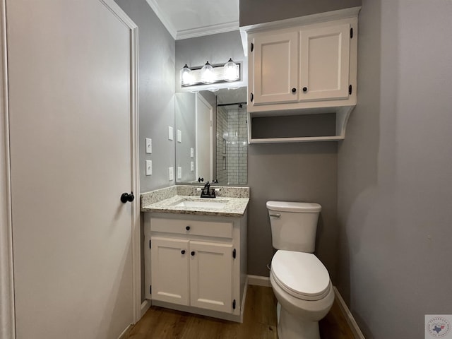 bathroom with hardwood / wood-style floors, toilet, vanity, and ornamental molding