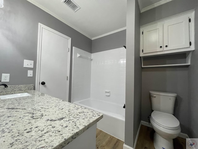 full bathroom featuring bathtub / shower combination, hardwood / wood-style floors, toilet, vanity, and ornamental molding