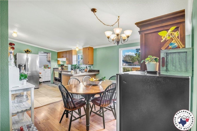 2520 County Road 326, W, TX 75706 - dining area with crown molding, a chandelier, washer and clothes dryer, and light wood-style flooring