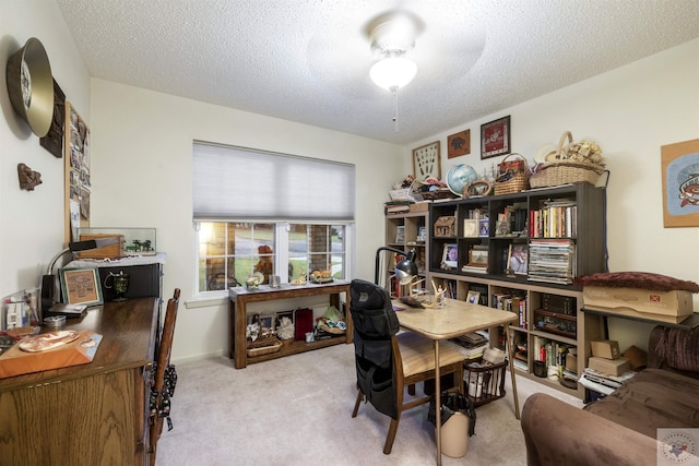 home office with a textured ceiling and light carpet