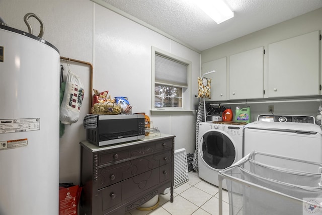 laundry room featuring a textured ceiling, cabinets, independent washer and dryer, light tile patterned flooring, and gas water heater