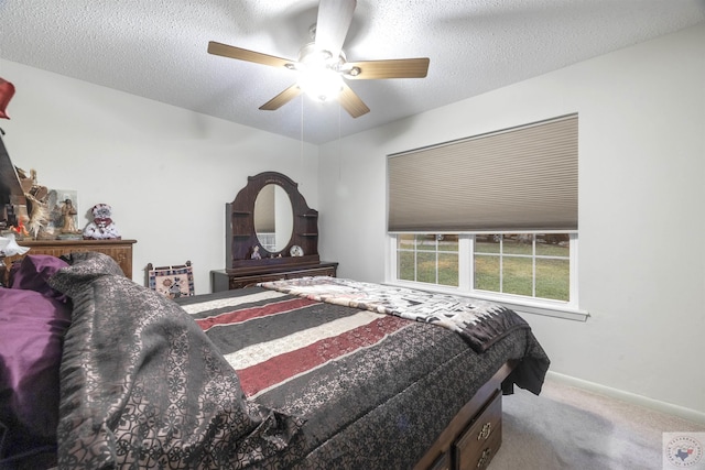 carpeted bedroom with a textured ceiling and ceiling fan