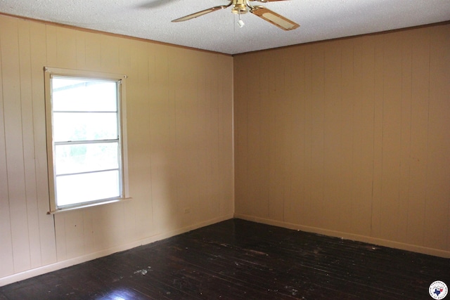 403NFOSTER N Foster St, Linden, TX 75563 - unfurnished room featuring hardwood / wood-style floors, ceiling fan, wooden walls, and a textured ceiling