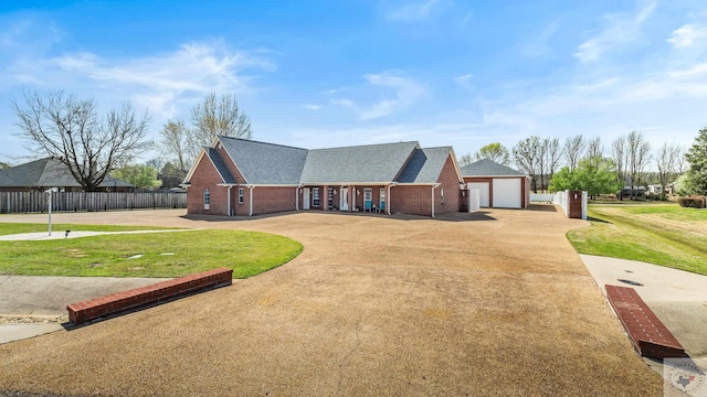7207 N Richland Dr, Texarkana, TX 75503 - view of front facade with driveway, a front lawn, fence, a garage, and brick siding