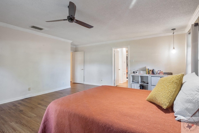 bedroom with a textured ceiling, dark hardwood / wood-style flooring, ornamental molding, ceiling fan, and ensuite bathroom