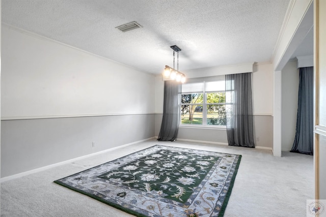 interior space featuring light colored carpet, a textured ceiling, and crown molding