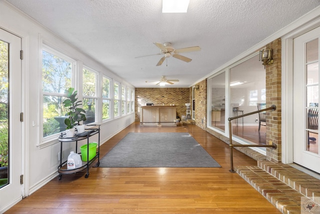 sunroom / solarium featuring ceiling fan and a wealth of natural light