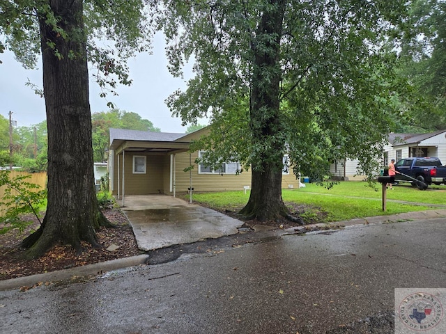 view of front of home featuring a carport and a front lawn