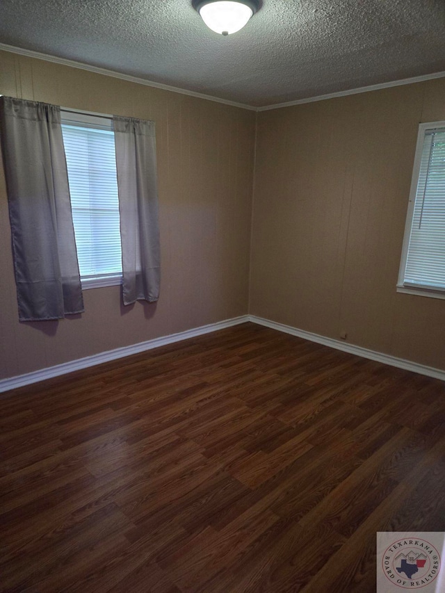 unfurnished room with a textured ceiling, dark hardwood / wood-style floors, and ornamental molding