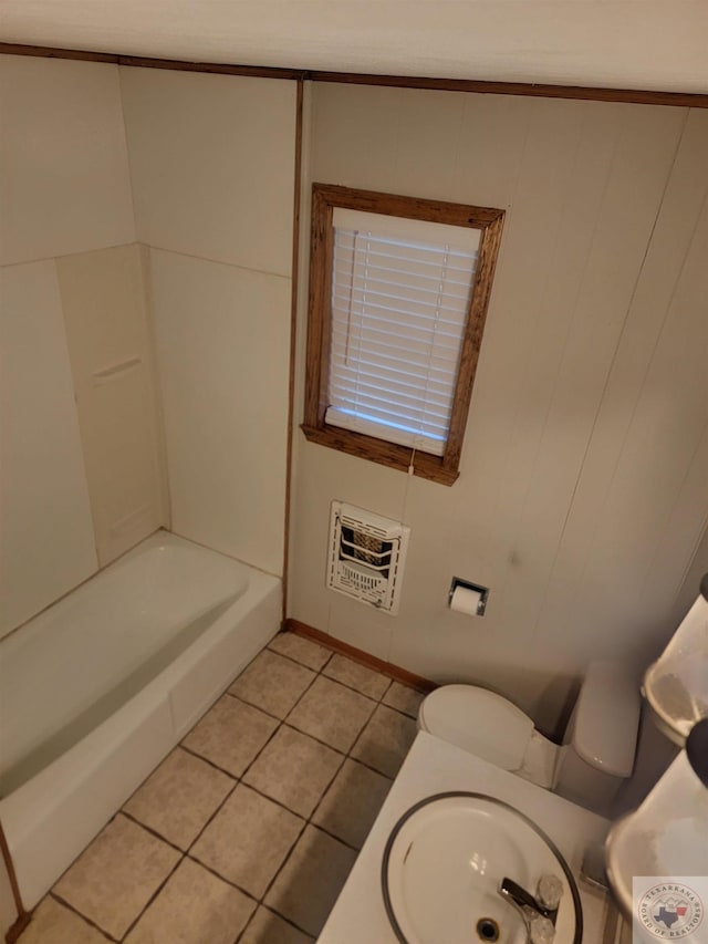 bathroom featuring tile patterned floors, sink, toilet, heating unit, and a washtub