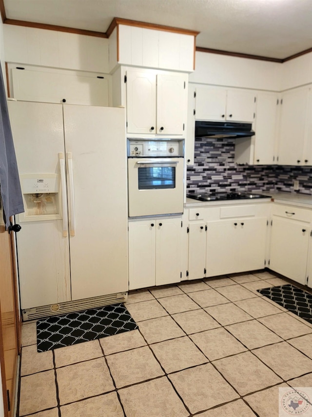 kitchen with white appliances, white cabinetry, light tile patterned floors, ornamental molding, and backsplash