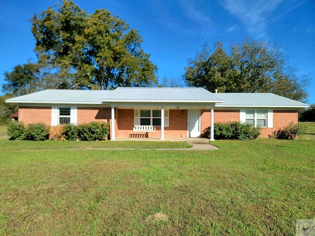 ranch-style house featuring a porch and a front yard