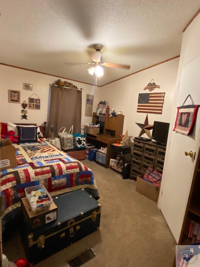 carpeted bedroom featuring ceiling fan, a textured ceiling, and crown molding