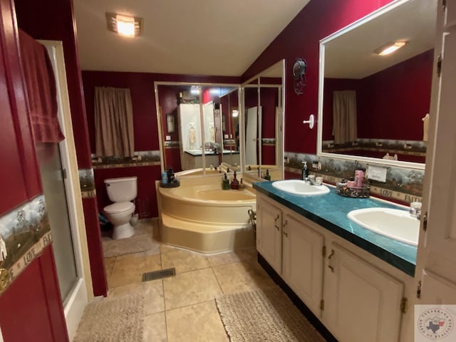 bathroom with tile patterned flooring, vanity, a bathtub, toilet, and vaulted ceiling