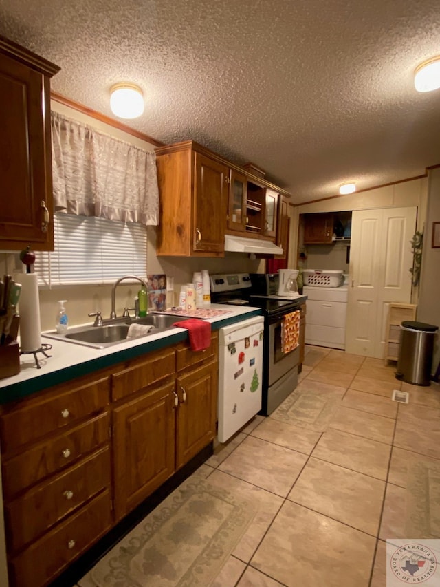 kitchen with white dishwasher, a textured ceiling, sink, electric range, and washer and dryer