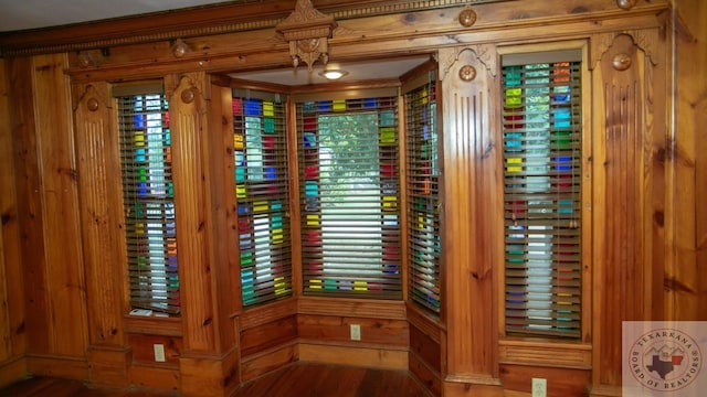 room details featuring wood walls and wood-type flooring