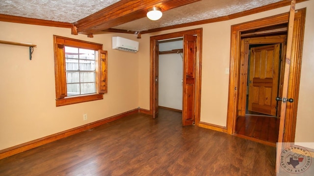 unfurnished bedroom with a closet, dark wood-type flooring, a textured ceiling, and a wall unit AC