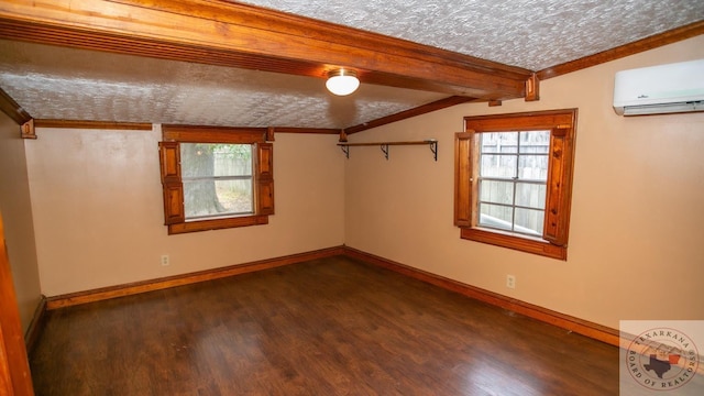 unfurnished room featuring crown molding, dark wood-type flooring, a textured ceiling, vaulted ceiling with beams, and a wall mounted AC