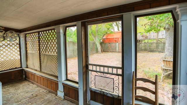 entryway with plenty of natural light and wooden walls