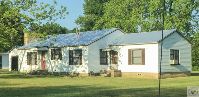 view of front of property with a front lawn and cooling unit