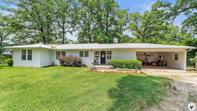 9216 W 7th St, Redwater, TX 75501 - view of front facade with a carport, a front lawn, driveway, and metal roof