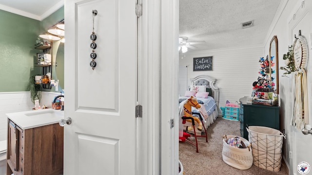 9216 W 7th St, Redwater, TX 75501 - bedroom with a sink, carpet, a textured ceiling, and crown molding