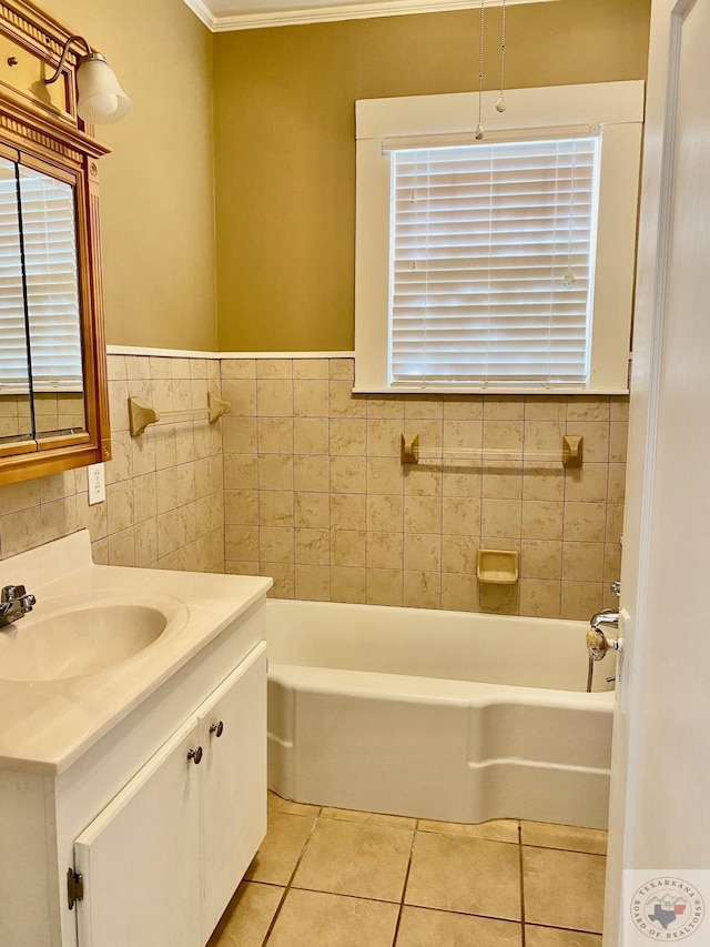 bathroom with tile patterned flooring, vanity, tile walls, a bathtub, and crown molding