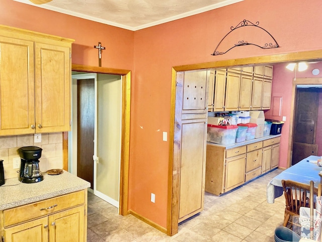 kitchen featuring crown molding and tasteful backsplash