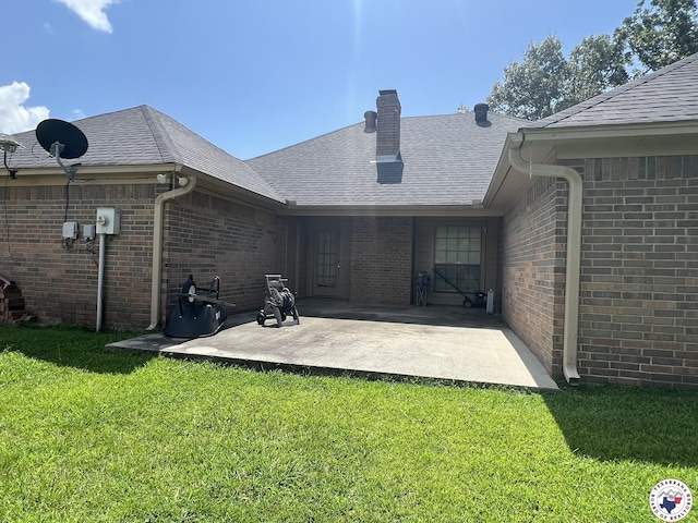 5902 Oak Hollow Pl, Texarkana, AR 71854 - rear view of house featuring brick siding, a chimney, a lawn, and a patio