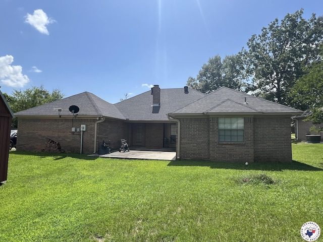 5902 Oak Hollow Pl, Texarkana, AR 71854 - back of property with a patio, a yard, brick siding, a chimney, and a shingled roof