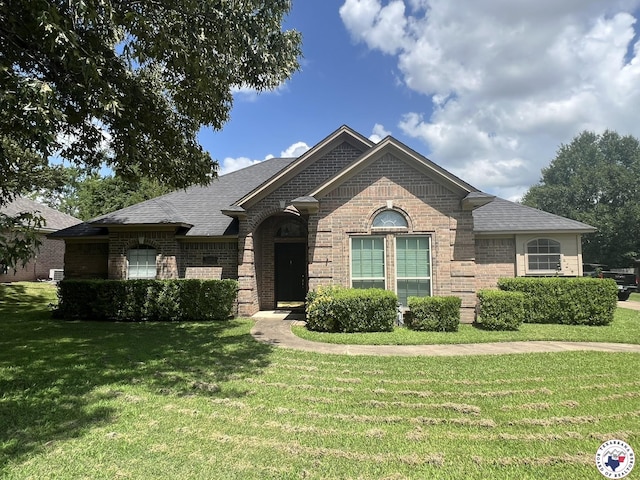 5902 Oak Hollow Pl, Texarkana, AR 71854 - french country inspired facade with brick siding, a front yard, and a shingled roof