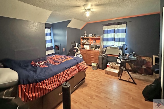 bedroom featuring a textured ceiling, a ceiling fan, and wood finished floors