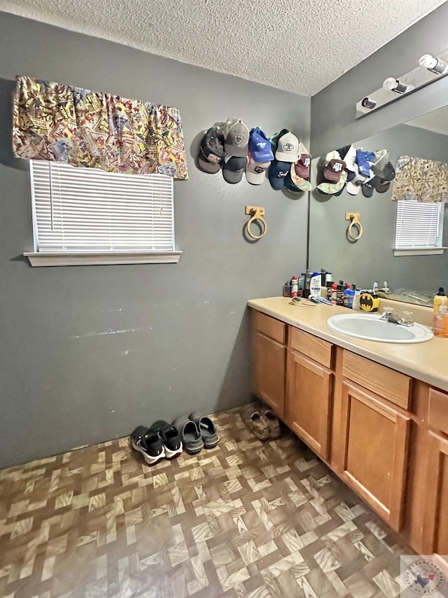 bathroom featuring a textured ceiling and vanity