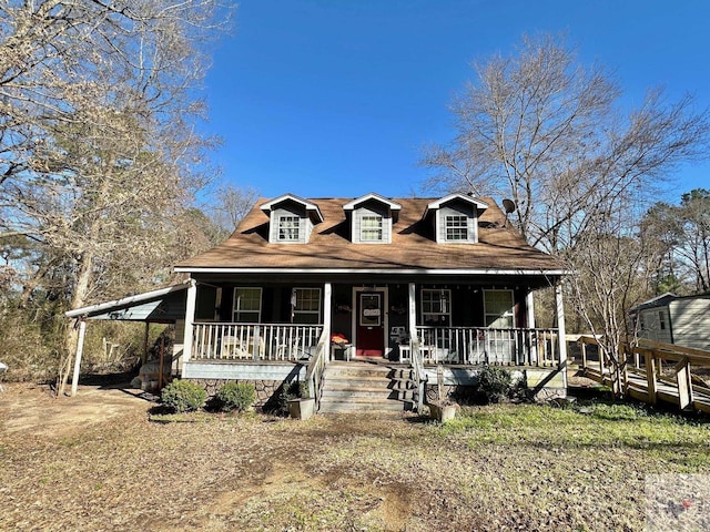 view of front of property with a porch and a carport