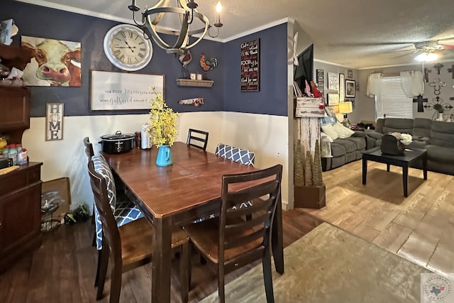 dining room featuring ornamental molding, wood finished floors, and ceiling fan with notable chandelier