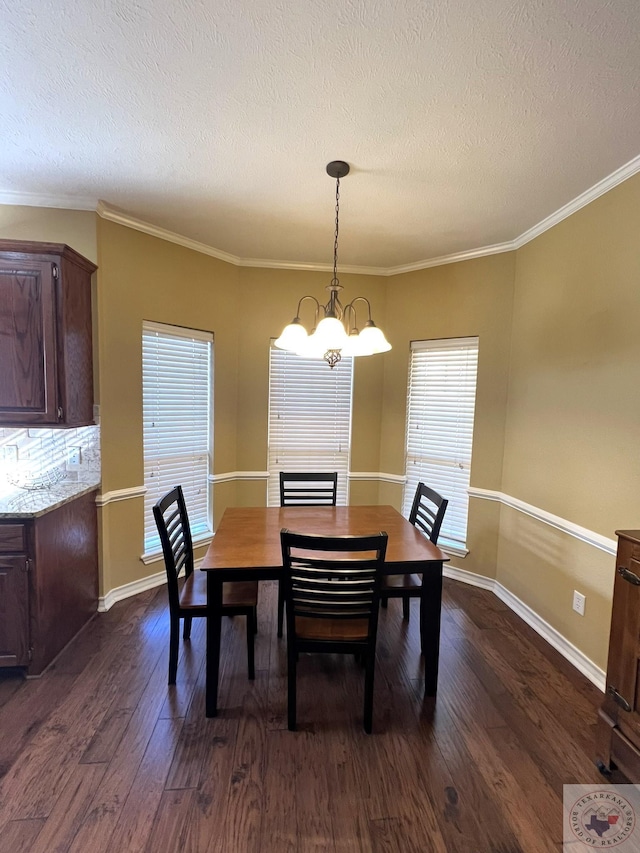 dining room with ornamental molding, an inviting chandelier, and dark hardwood / wood-style flooring