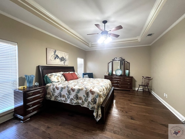 bedroom with ceiling fan, multiple windows, crown molding, and a raised ceiling