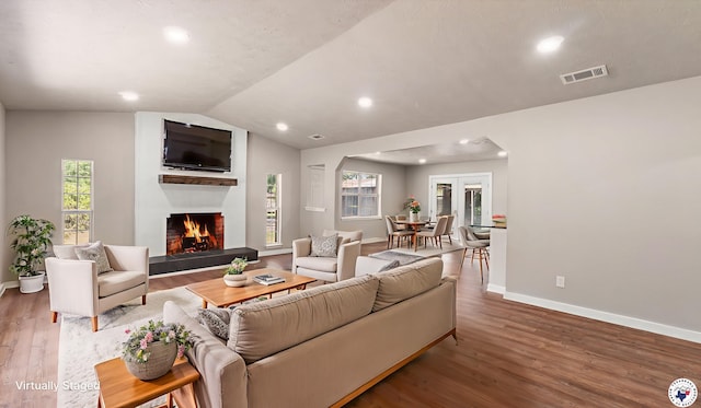 1911 Vanderbilt Rd, Texarkana, AR 71854 - living area with wood finished floors, recessed lighting, a lit fireplace, healthy amount of natural light, and lofted ceiling
