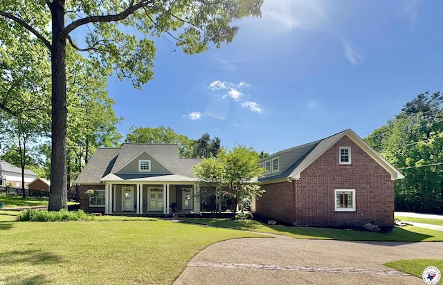 view of front of home with a front yard and brick siding