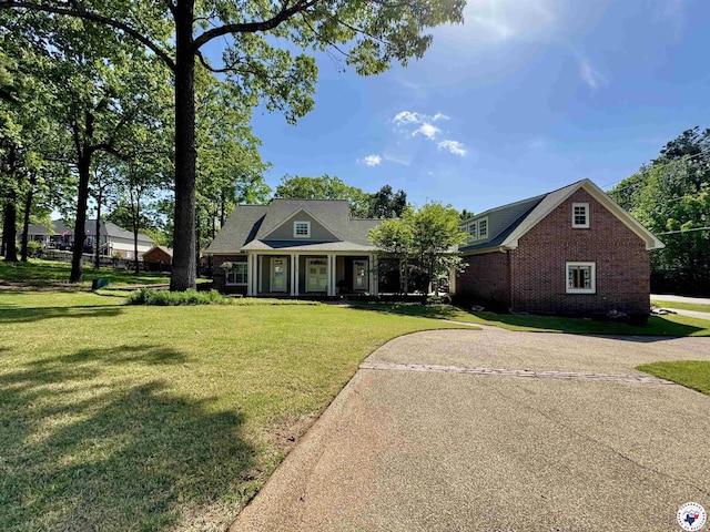 view of front of house featuring a front yard and brick siding
