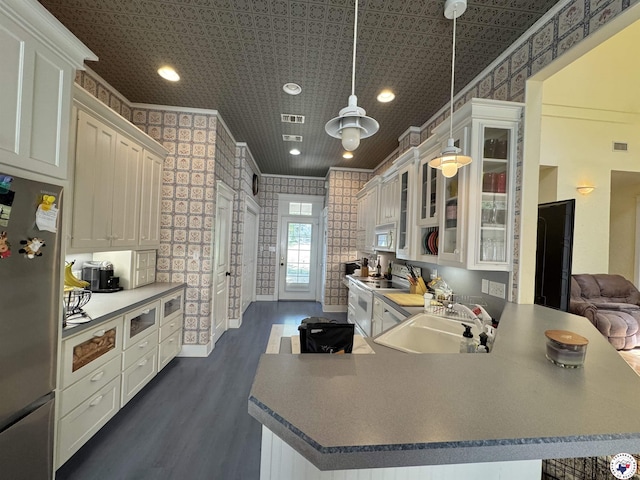 kitchen featuring white appliances, dark wood-style floors, white cabinetry, crown molding, and a sink