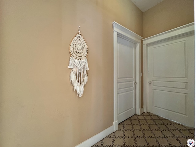 interior space with baseboards and light colored carpet