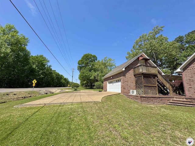 view of side of property featuring a yard, brick siding, stairs, an attached garage, and driveway