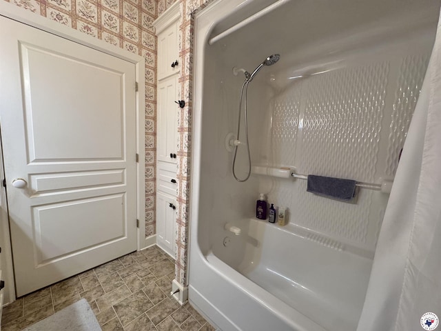 full bathroom featuring shower / bath combo and wallpapered walls