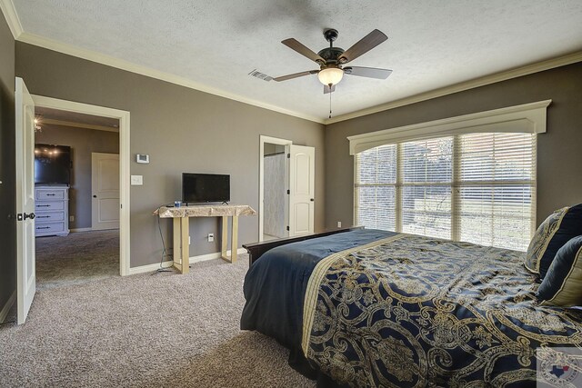 carpeted bedroom with a textured ceiling, ceiling fan, and ornamental molding