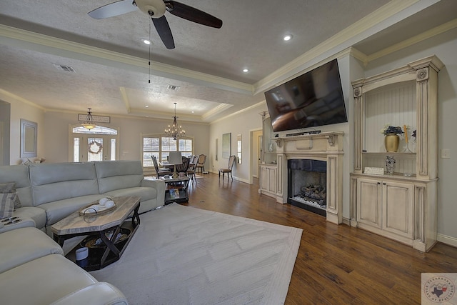 living room featuring ornamental molding, a tray ceiling, and dark hardwood / wood-style flooring