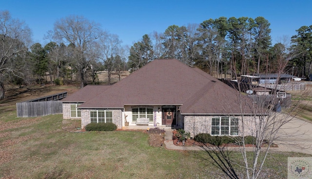 view of front of property with a porch and a front lawn