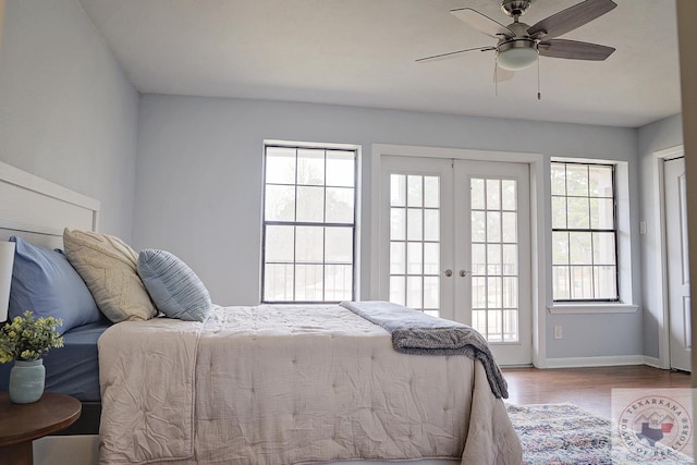 bedroom featuring baseboards, ceiling fan, wood finished floors, access to outside, and french doors