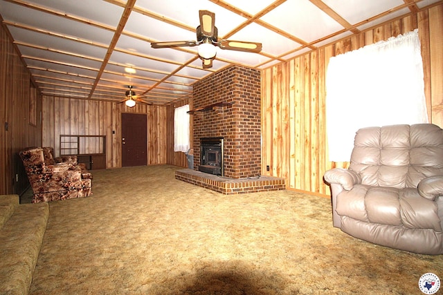 334 Pine Valley Rd, Texarkana, TX 75501 - carpeted living room featuring ceiling fan, wooden walls, and a brick fireplace