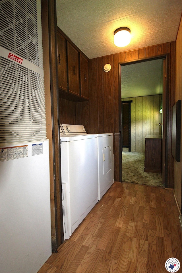334 Pine Valley Rd, Texarkana, TX 75501 - laundry room featuring cabinet space, a heating unit, wood finished floors, washer and dryer, and wood walls